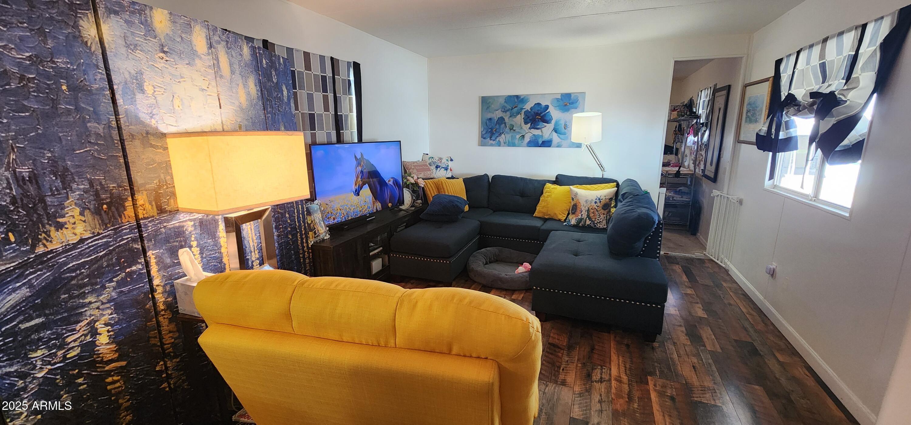 16005 North 32nd Street, Unit 33 Phoenix, AZ 85032 - Photo 14 of 40 a living room with furniture and a flat screen tv