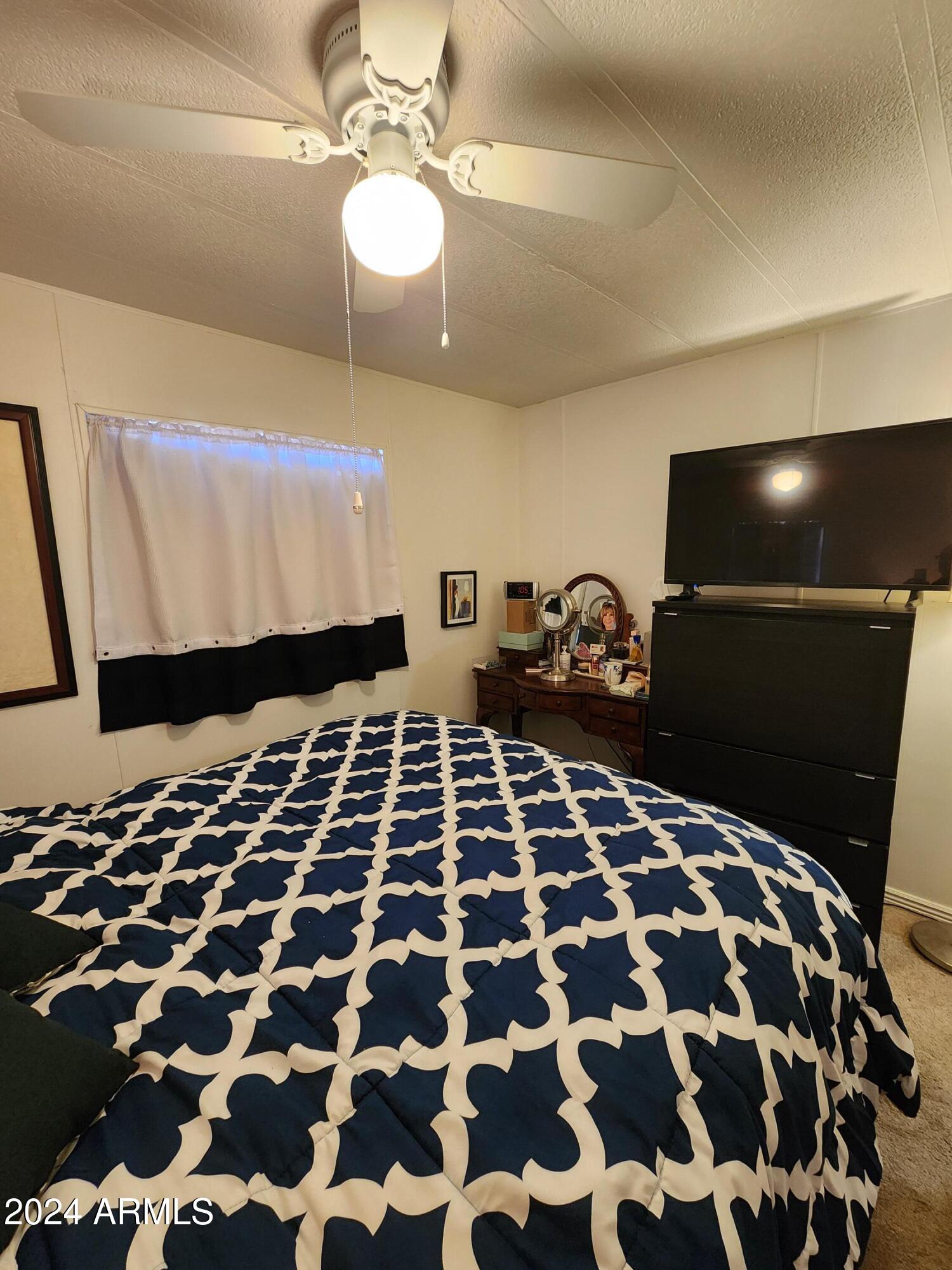 16005 North 32nd Street, Unit 33 Phoenix, AZ 85032 - Photo 17 of 40 a bedroom with a bed and a mirror