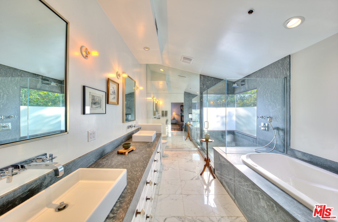 663 Hightree Road Santa Monica, CA 90402 - Photo 22 of 37 a bathroom with a tub a double vanity sink and mirror