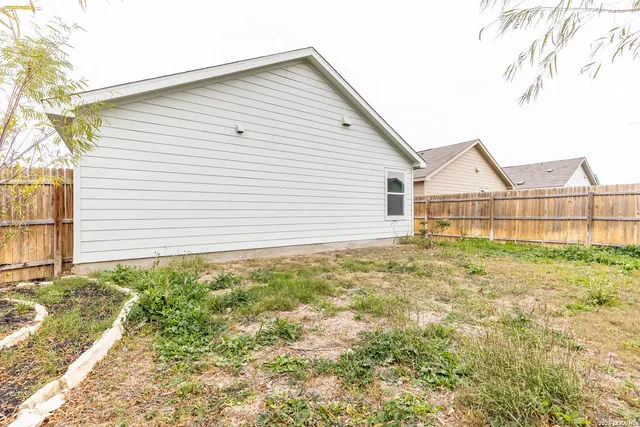a view of a backyard of the house