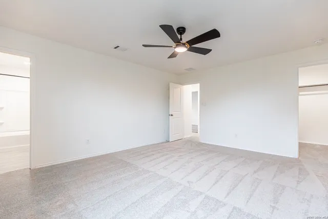 a view of a big room with wooden floor closet and windows