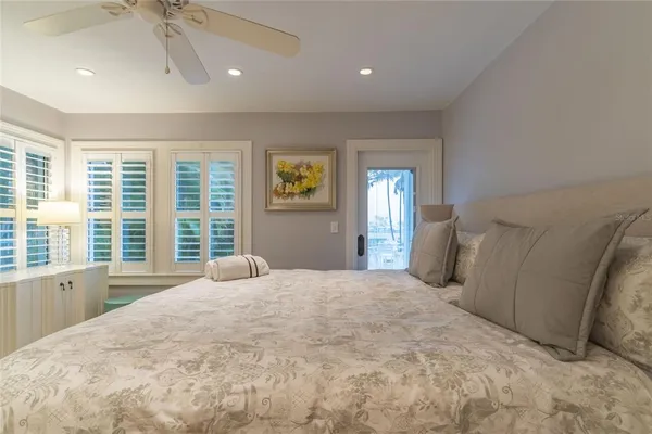 a bedroom with a bed and painting on the wall