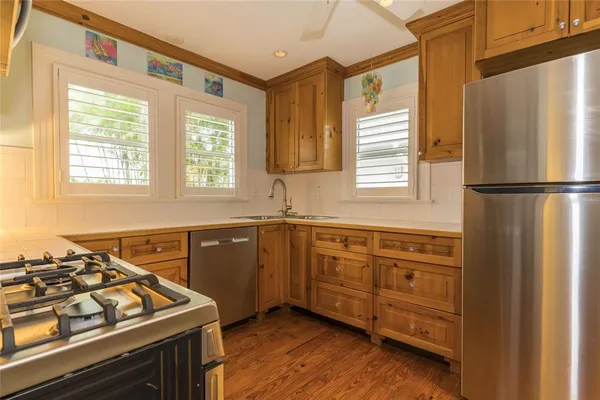 a kitchen with a sink stove and microwave