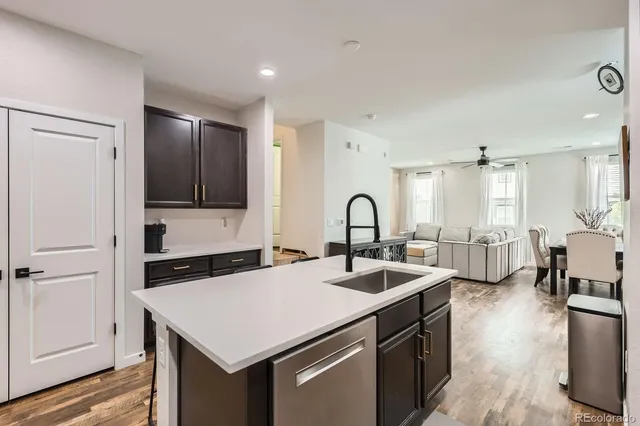 a kitchen with a sink appliances and cabinets