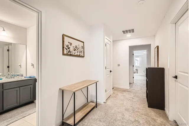 a view of a hallway with bathroom