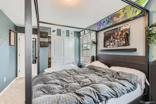 a bedroom with a large bed and a chandelier