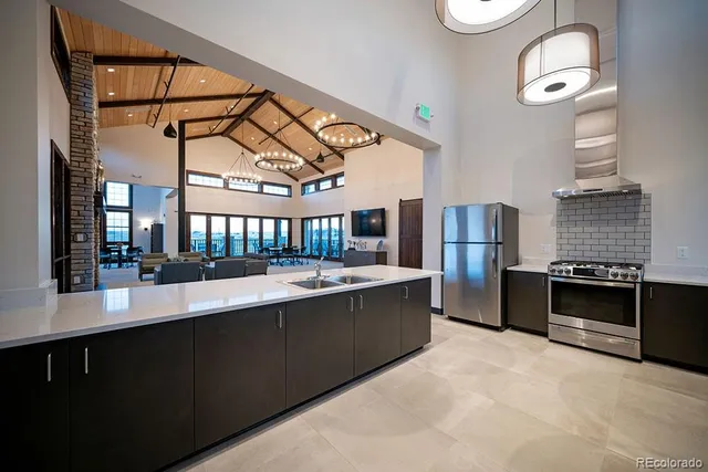 a kitchen with refrigerator and cabinets