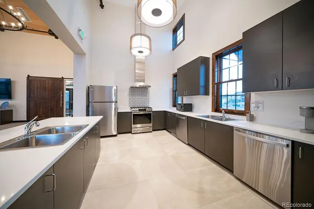 a large kitchen with a large window and stainless steel appliances