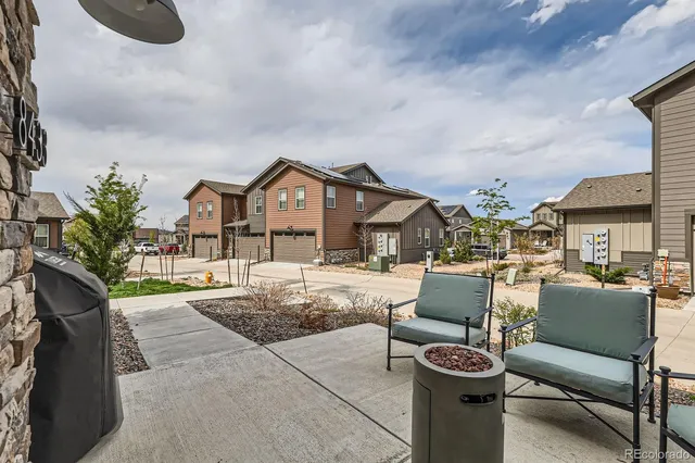 a view of couches and a table and chairs in patio