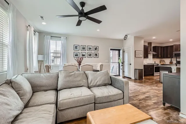 a living room with furniture and kitchen view