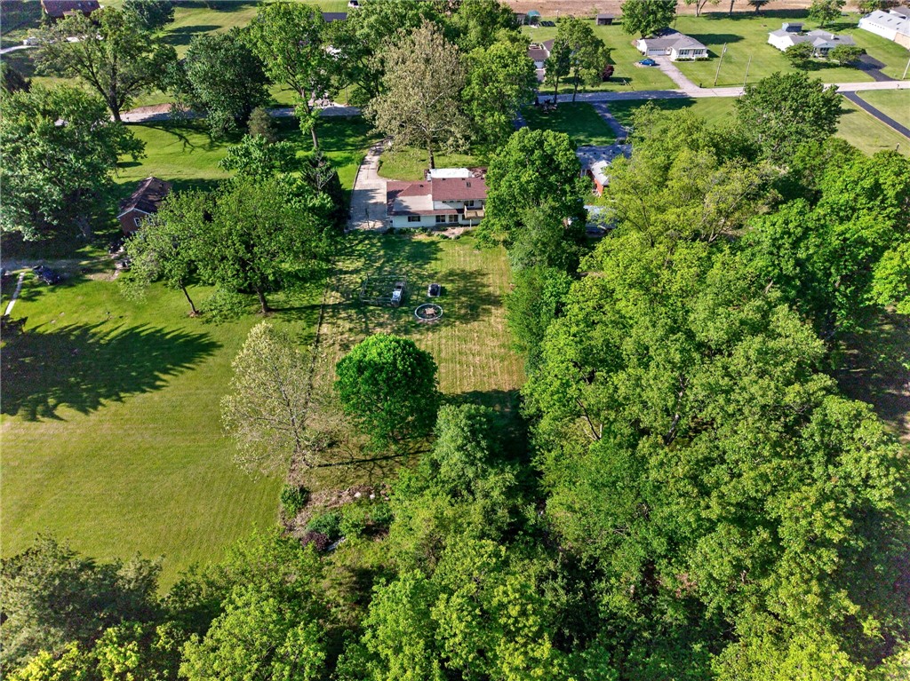 2684 Arthur Road Springfield, OH 45502 - Photo 63 of 69 This verdant aerial view reveals a charming home nestled among lush trees and open green spaces.