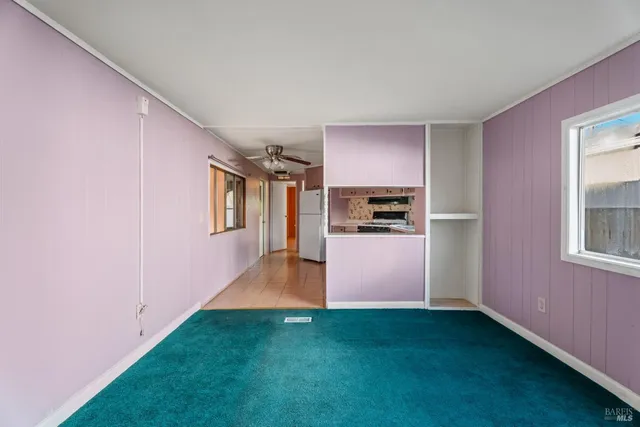 a kitchen with a refrigerator a stove top oven and cabinets