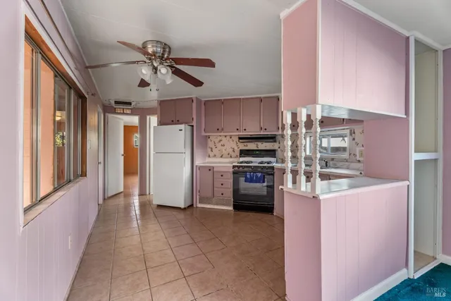 a kitchen with cabinets stainless steel appliances and a counter space