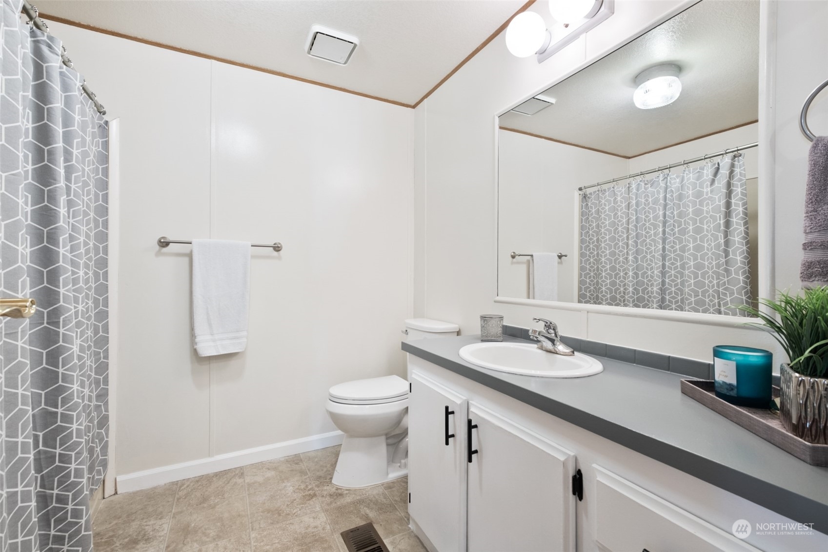 798 Pine Drive, Unit 798 Enumclaw, WA 98022 - Photo 17 of 20 a bathroom with a granite countertop sink and a mirror