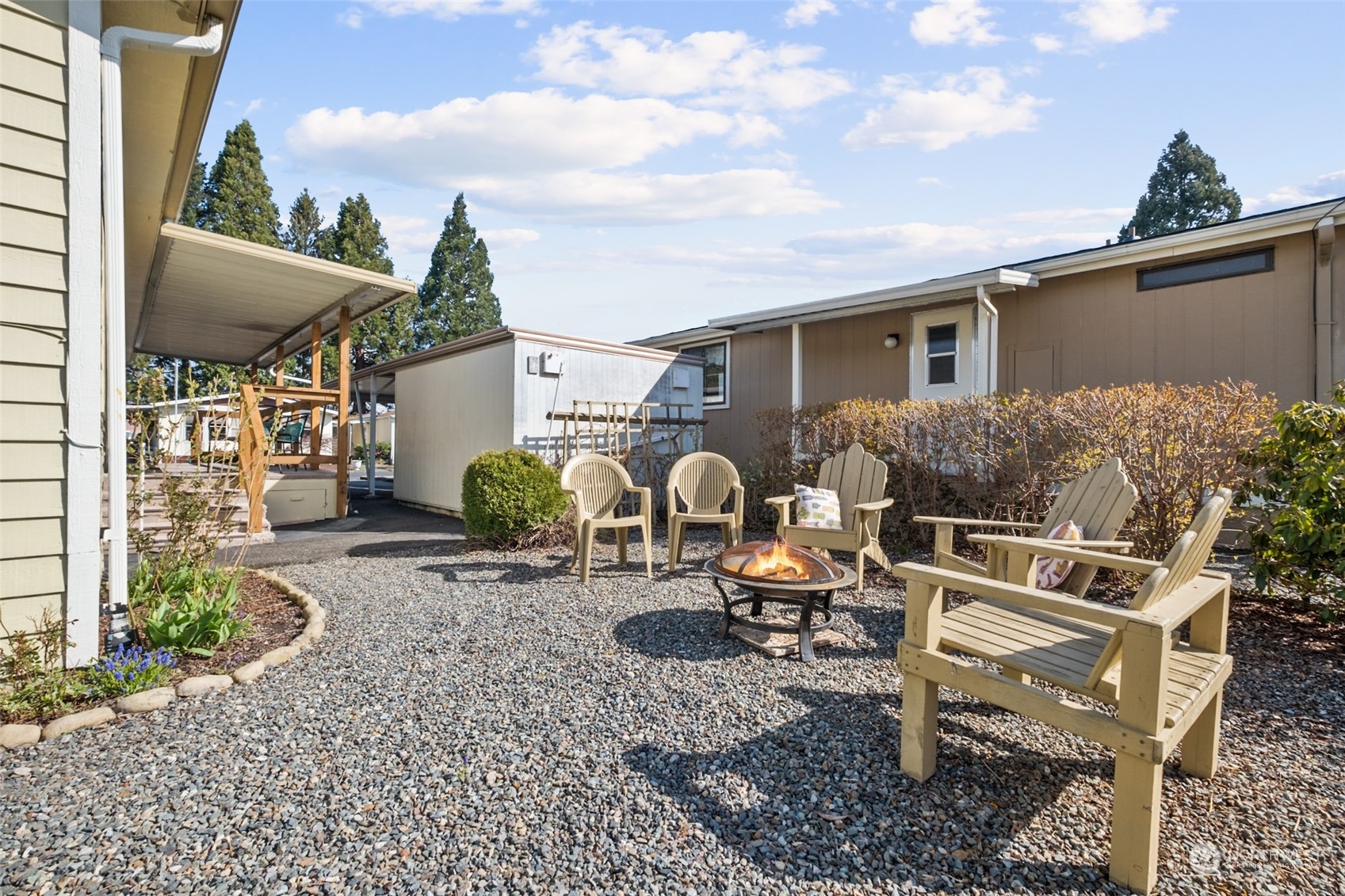 798 Pine Drive, Unit 798 Enumclaw, WA 98022 - Photo 19 of 20 a view of a backyard with plants and a patio