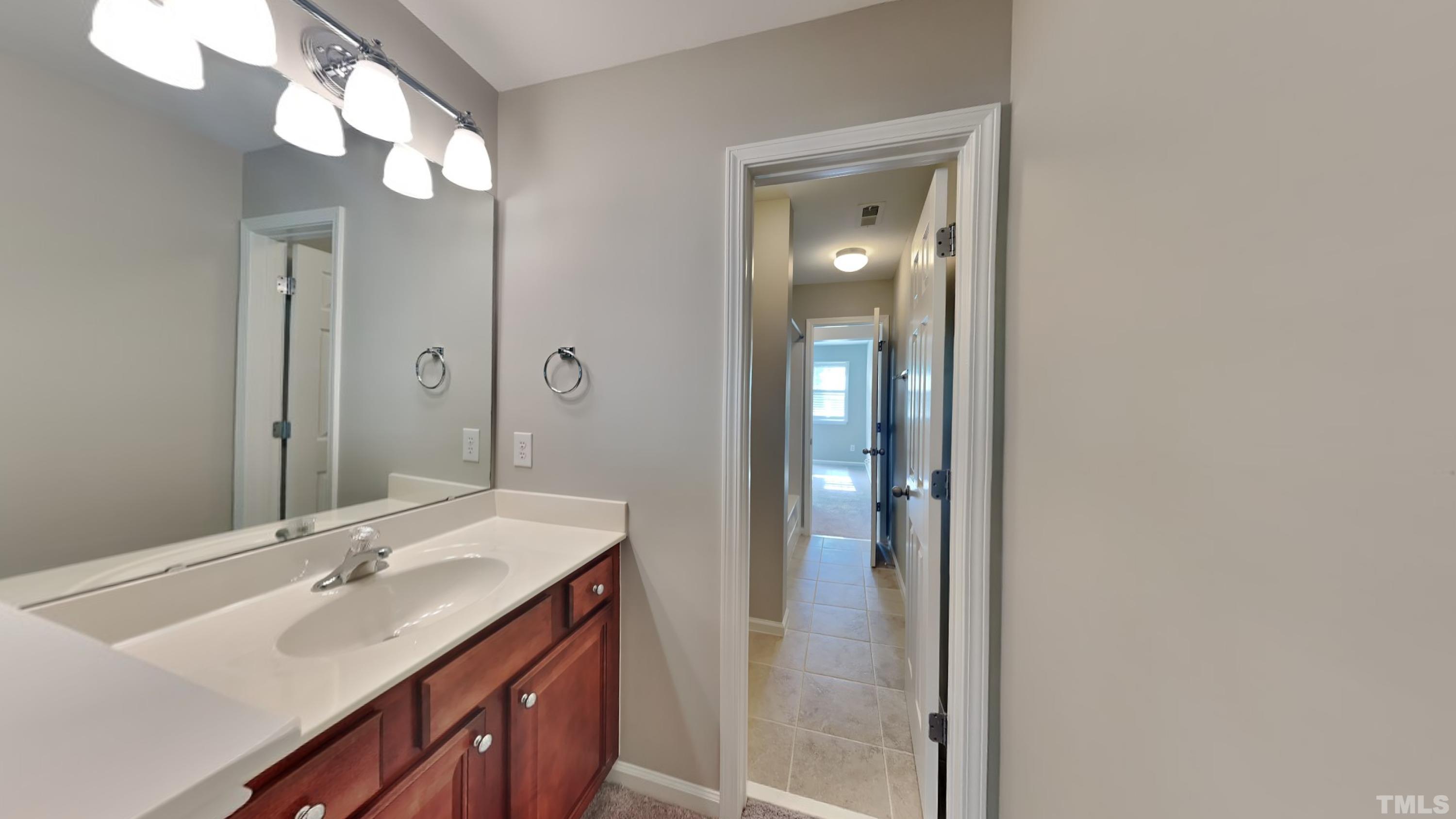 2 Water Garden Way Durham, NC 27713 - Photo 13 of 16 a bathroom with a double vanity sink and a mirror