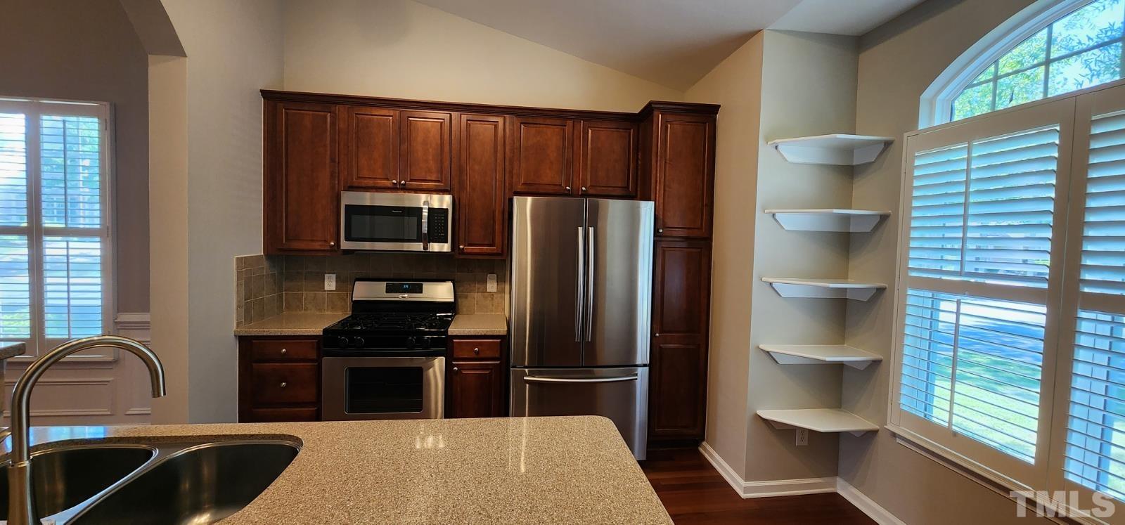 2 Water Garden Way Durham, NC 27713 - Photo 6 of 16 a kitchen with granite countertop a refrigerator and a sink
