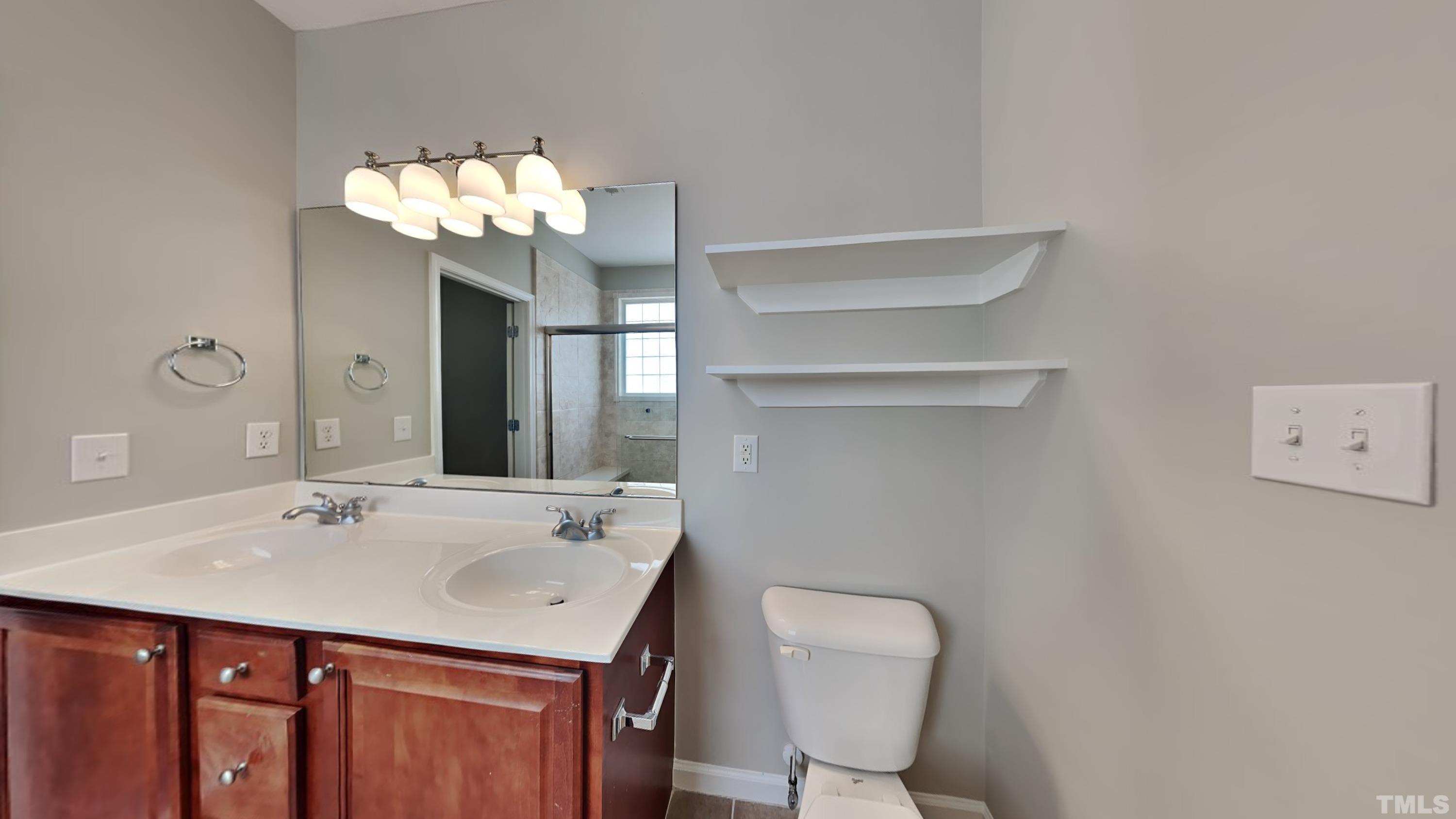 2 Water Garden Way Durham, NC 27713 - Photo 9 of 16 a bathroom with a sink vanity and a mirror