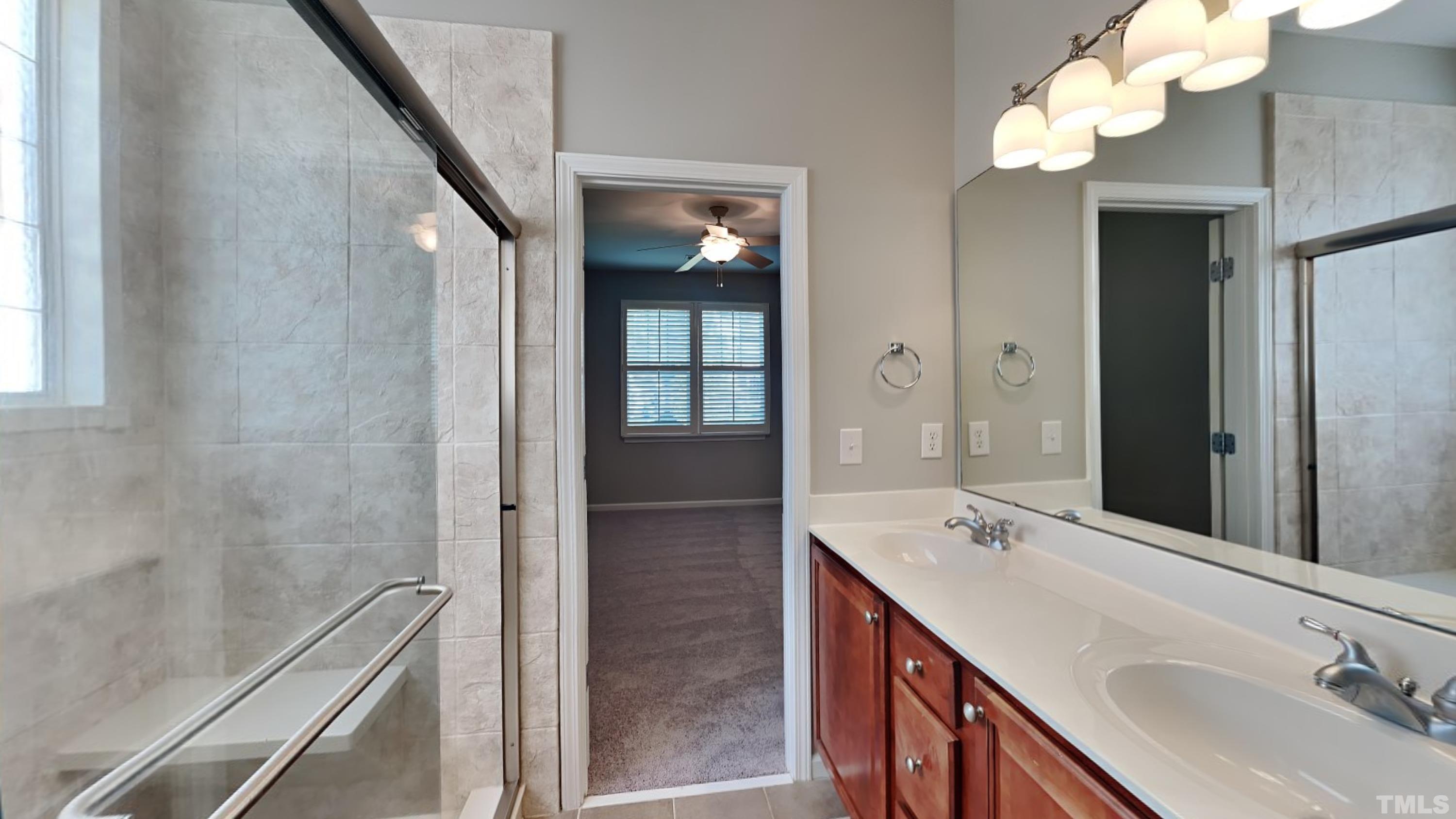 2 Water Garden Way Durham, NC 27713 - Photo 10 of 16 a bathroom with a double vanity sink and a mirror
