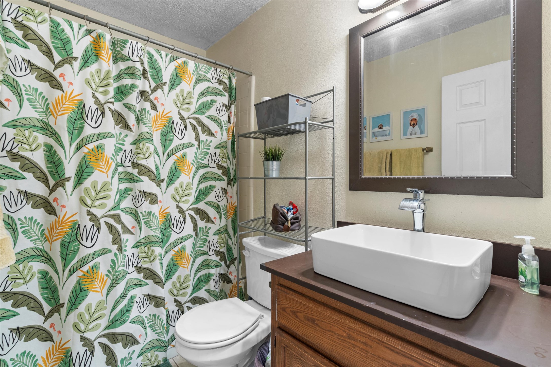 6492 Hart Lane Austin, TX 78731 - Photo 12 of 22 Full bath with a textured wall, a shower with curtain, vanity, and a textured ceiling
