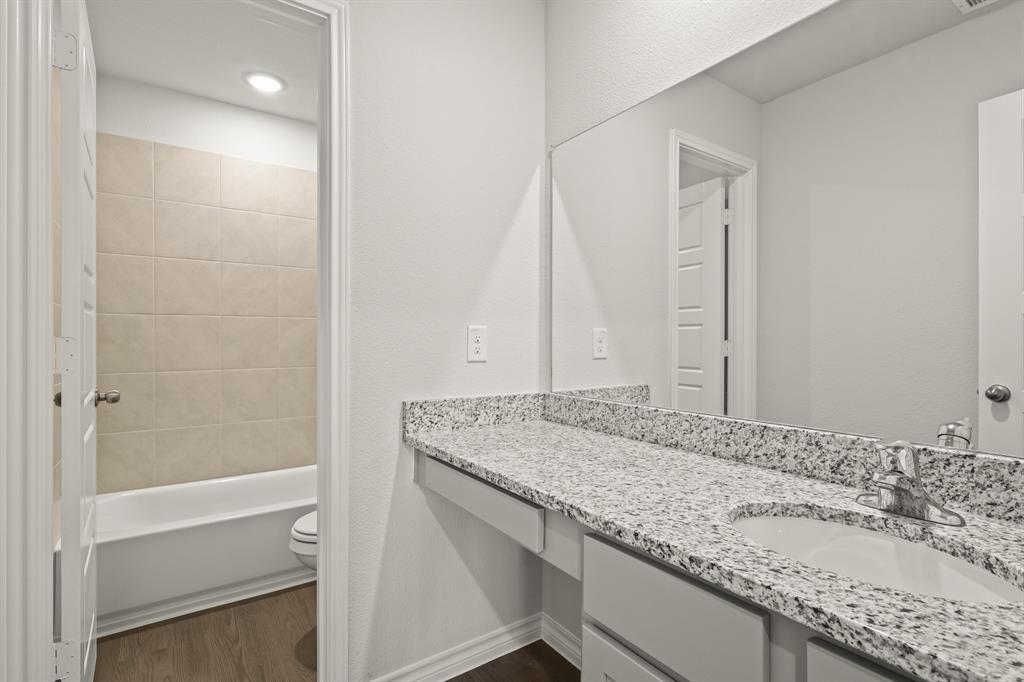 5025 Wellborn Road Crowley, TX 76036 - Photo 14 of 38 a bathroom with a granite countertop sink and a mirror