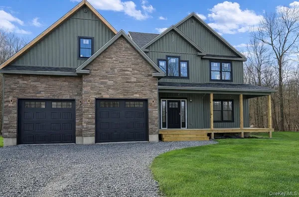 a front view of a house with a yard and garage