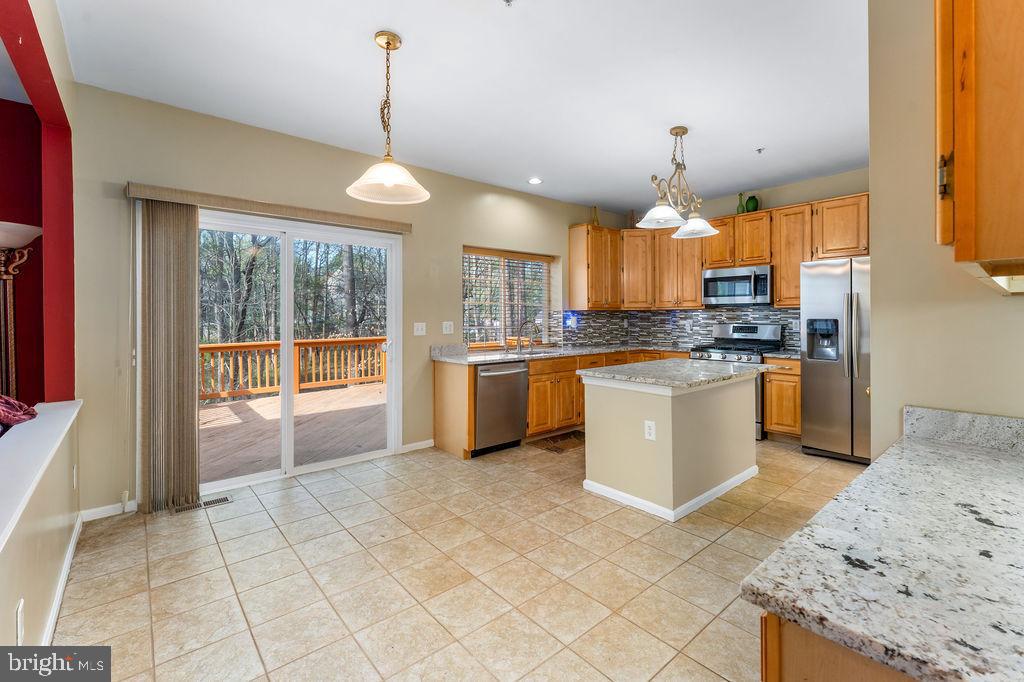 14701 Danton Court Bowie, MD 20721 - Photo 14 of 60 a kitchen with stainless steel appliances granite countertop a stove top oven a sink a counter top space cabinets and a window