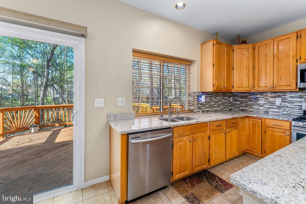 14701 Danton Court Bowie, MD 20721 - Photo 17 of 60 a kitchen with stainless steel appliances granite countertop wooden cabinets a sink and dishwasher