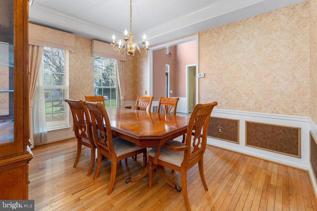 14701 Danton Court Bowie, MD 20721 - Photo 23 of 60 a dining room with furniture a chandelier and wooden floor