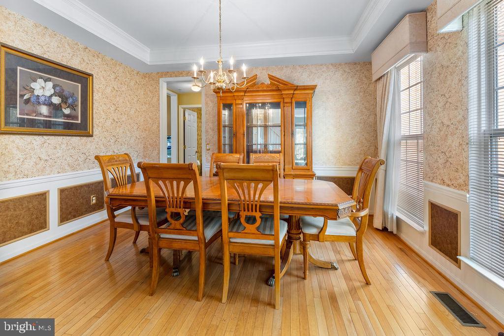 14701 Danton Court Bowie, MD 20721 - Photo 24 of 60 a view of a dining room with furniture a chandelier and wooden floor