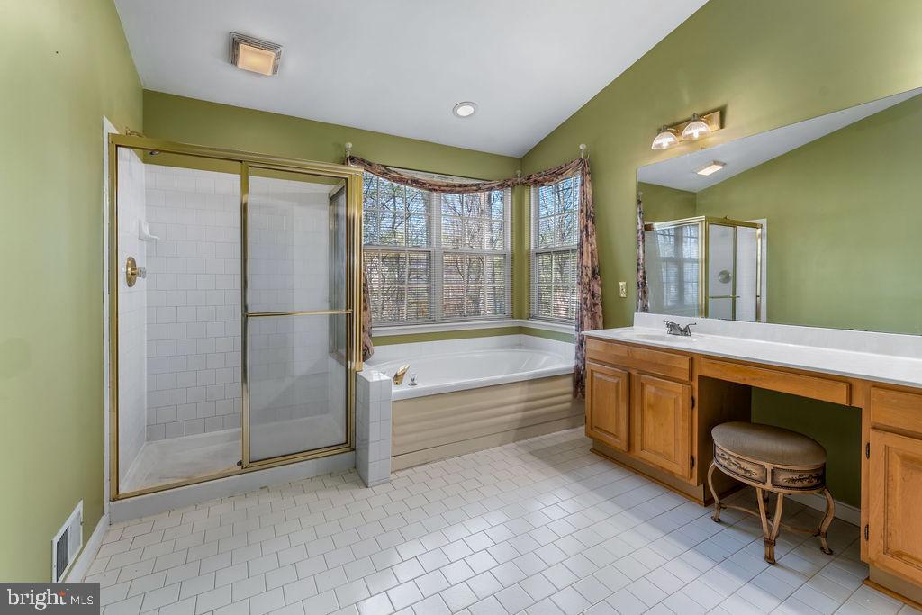 14701 Danton Court Bowie, MD 20721 - Photo 28 of 60 a bathroom with a tub sink shower and mirror