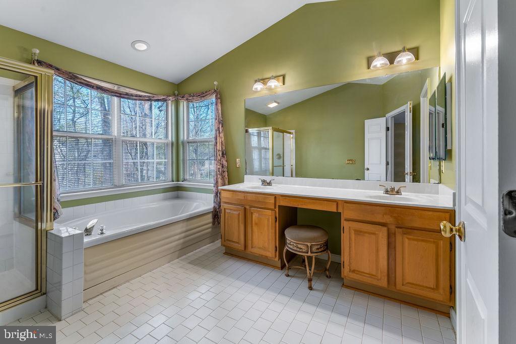 14701 Danton Court Bowie, MD 20721 - Photo 29 of 60 a large bathroom with a large tub sink and shower