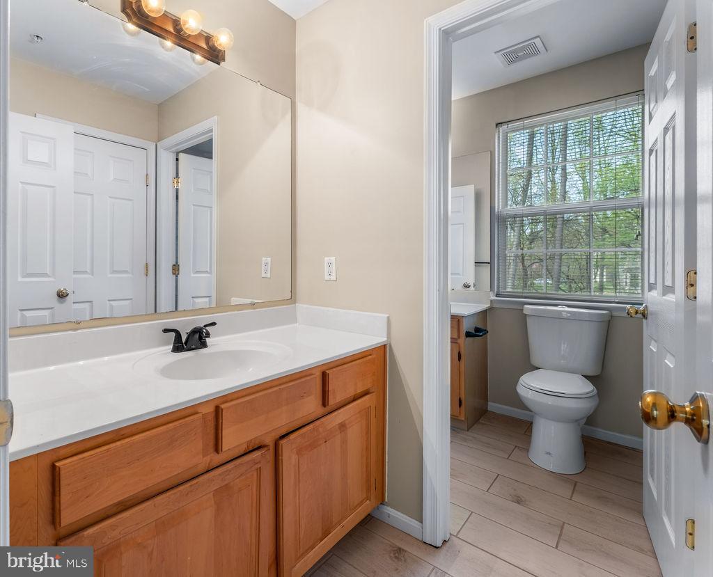 14701 Danton Court Bowie, MD 20721 - Photo 36 of 60 a bathroom with a toilet sink and mirror