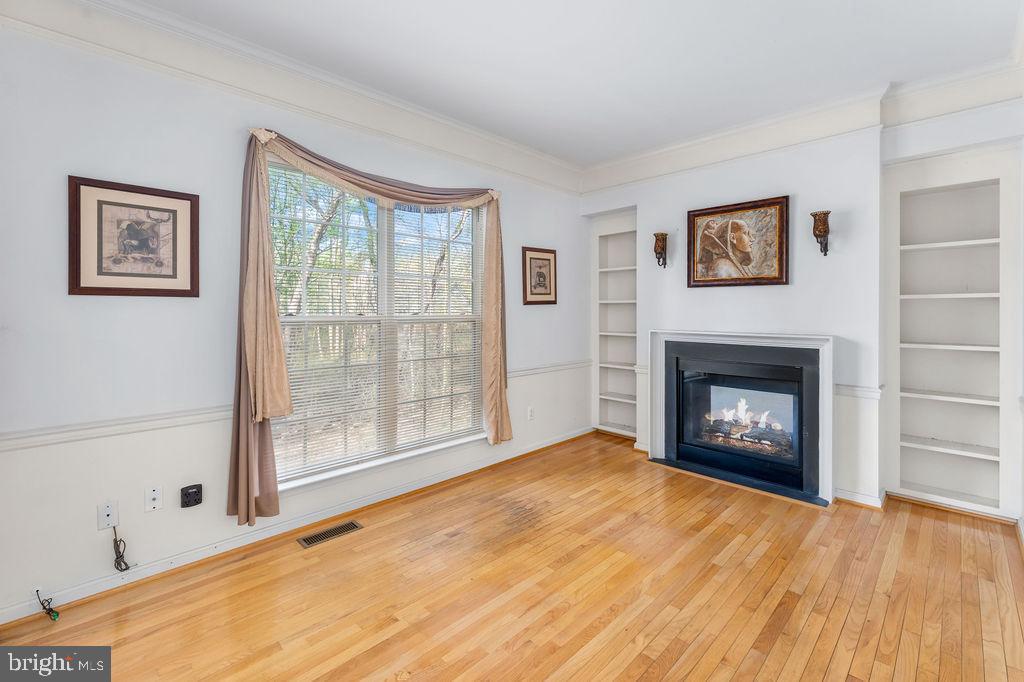 14701 Danton Court Bowie, MD 20721 - Photo 9 of 60 a view of an empty room with a window and a fireplace