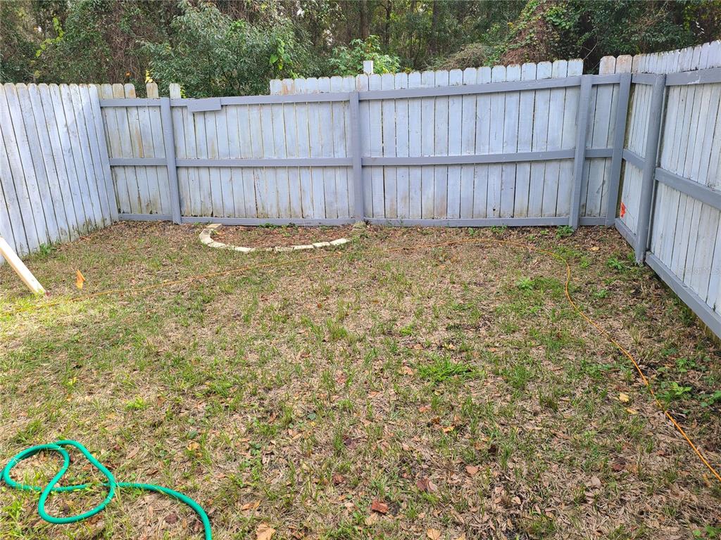 4123 Southwest 15 Place, Unit 2 Gainesville, FL 32607 - Photo 11 of 14 a view of a backyard with wooden fence