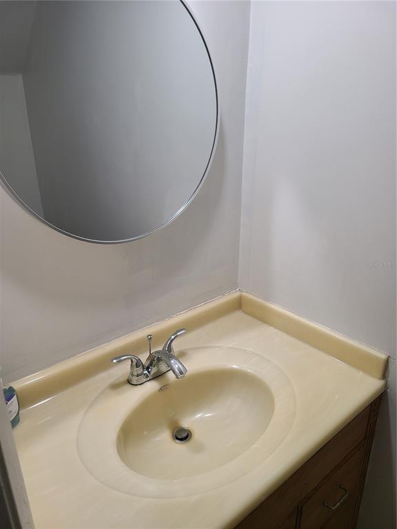4123 Southwest 15 Place, Unit 2 Gainesville, FL 32607 - Photo 13 of 14 a bathroom with a sink and a mirror