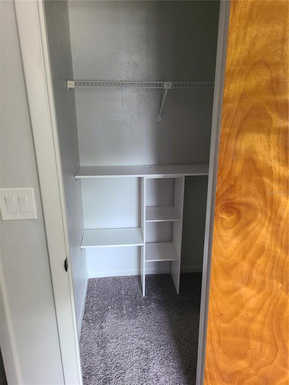 4123 Southwest 15 Place, Unit 2 Gainesville, FL 32607 - Photo 10 of 14 a view of walk in closet with empty racks