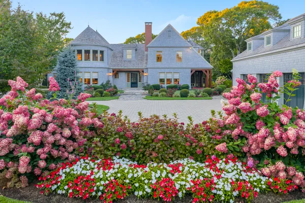 an aerial view of a house with a garden and yard