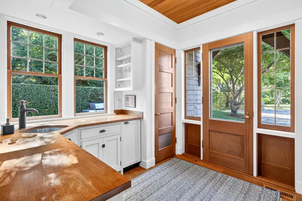 a dining room with wooden floor and a rug