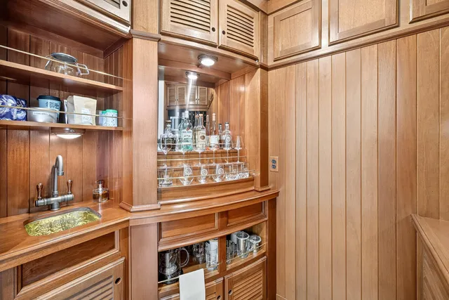 a dining room with wooden floor and a rug