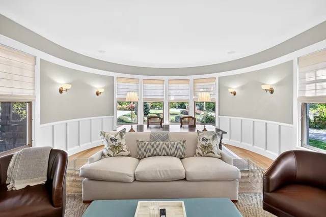 a view of backyard with seating space and trees