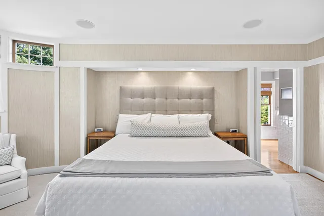 a front view of a house with a garden and plants