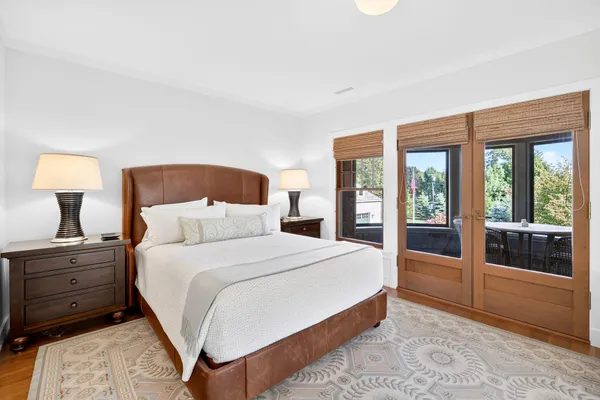 a front view of a house with a yard and potted plants