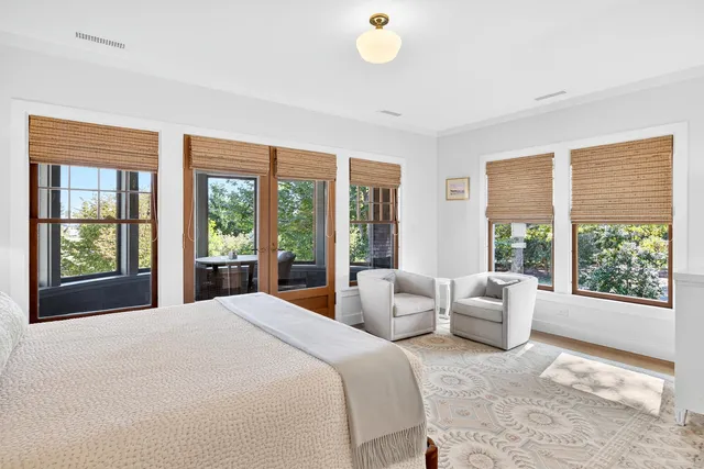 a front view of a house with a yard and potted plants