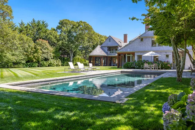 a picture of a room with a white wall and a painting
