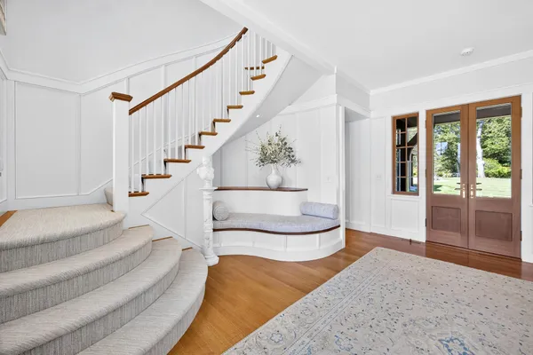 a living room with furniture fireplace and a window