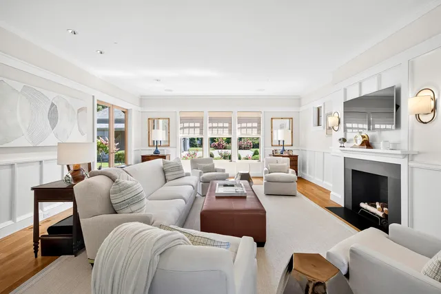 a living room with furniture a flat screen tv and a fireplace
