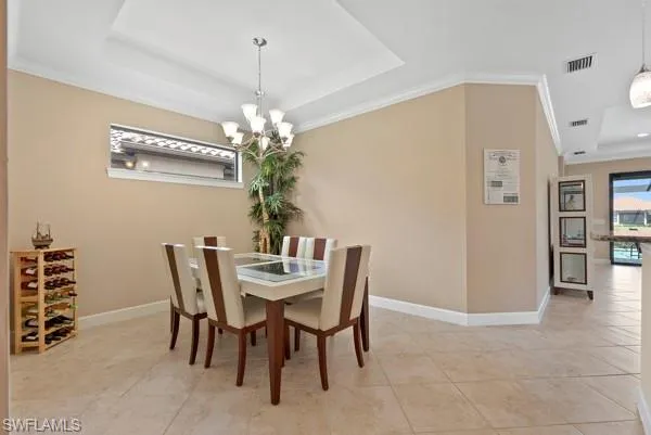 a view of a dining room with furniture and chandelier
