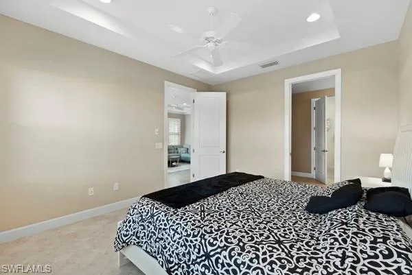 a bedroom with a large bed and a chandelier