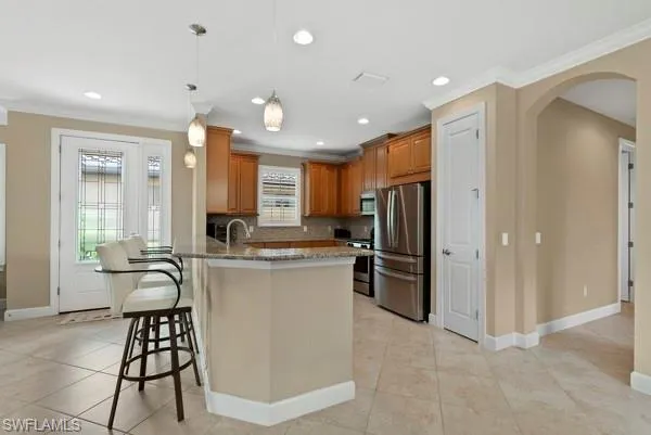 a kitchen with a refrigerator and wooden cabinets